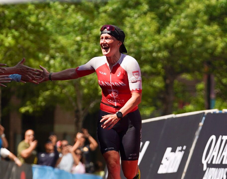 Kat Matthews high fives IRONMAN Texas finish line 2023